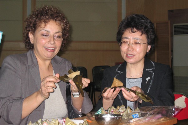 Dalian, China 2006: Sheri sharing local festivities with Principal of a school in Dalian after a training for the teachers of the school